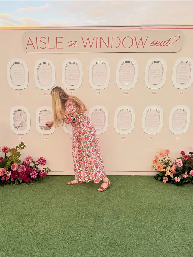 Travel themed seating chart styled like airplane windows with guest name cards