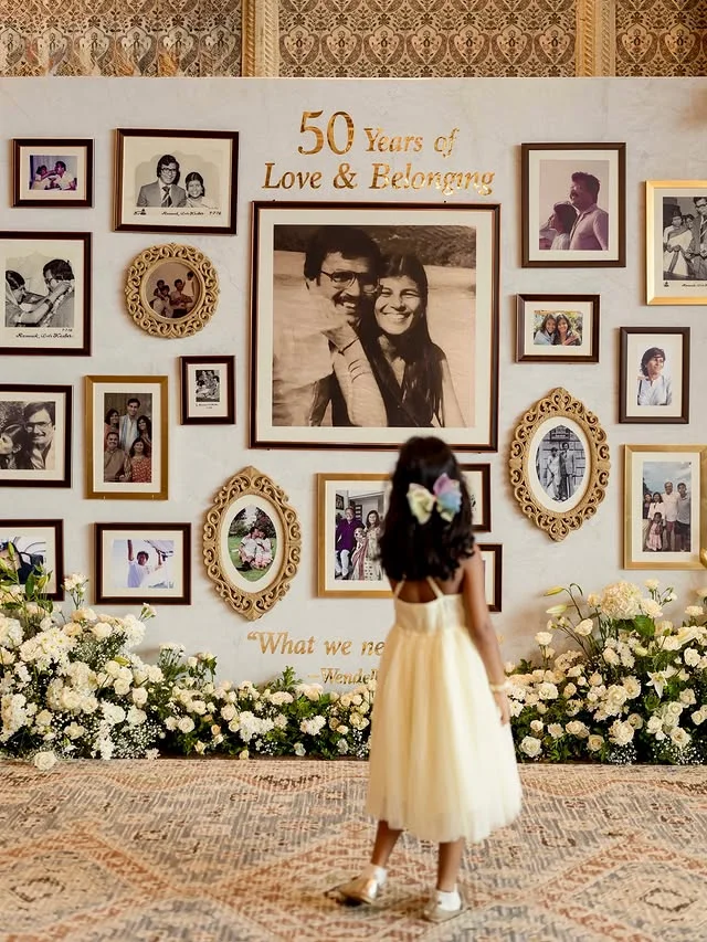 Memory wall covered with framed photographs and stories from a couple life together