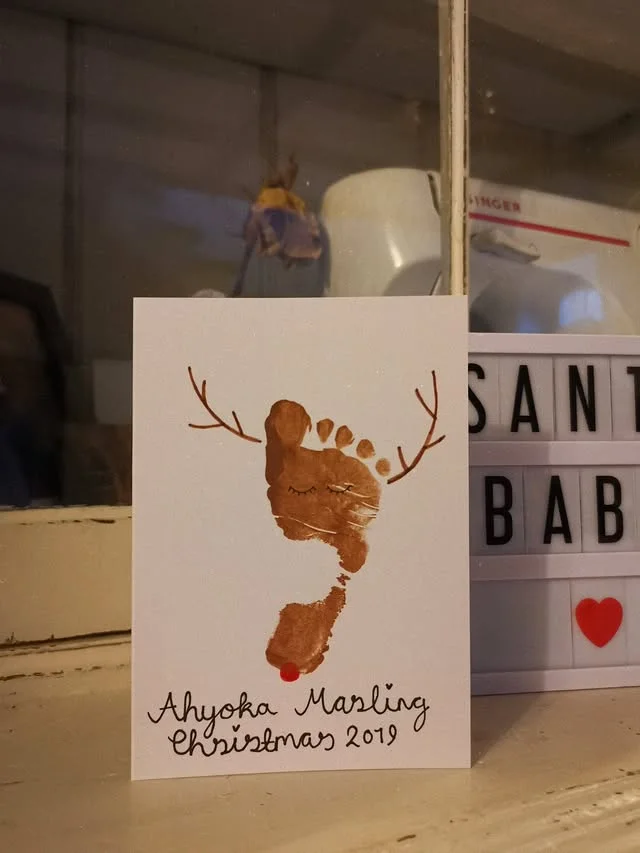 Footprint reindeer Christmas card with handwritten name and red nose