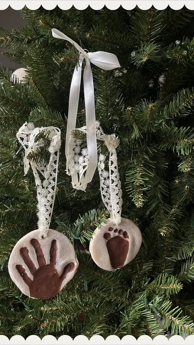 Salt dough handprint and footprint keepsake ornaments hanging on Christmas tree