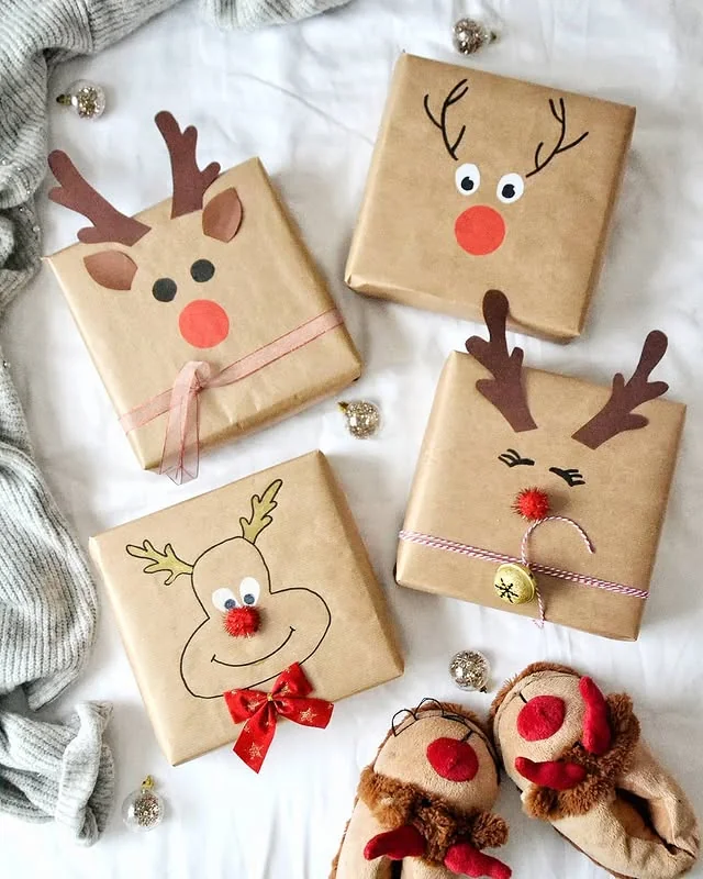 Kraft wrapped gifts with reindeer faces, antlers and red pompom noses