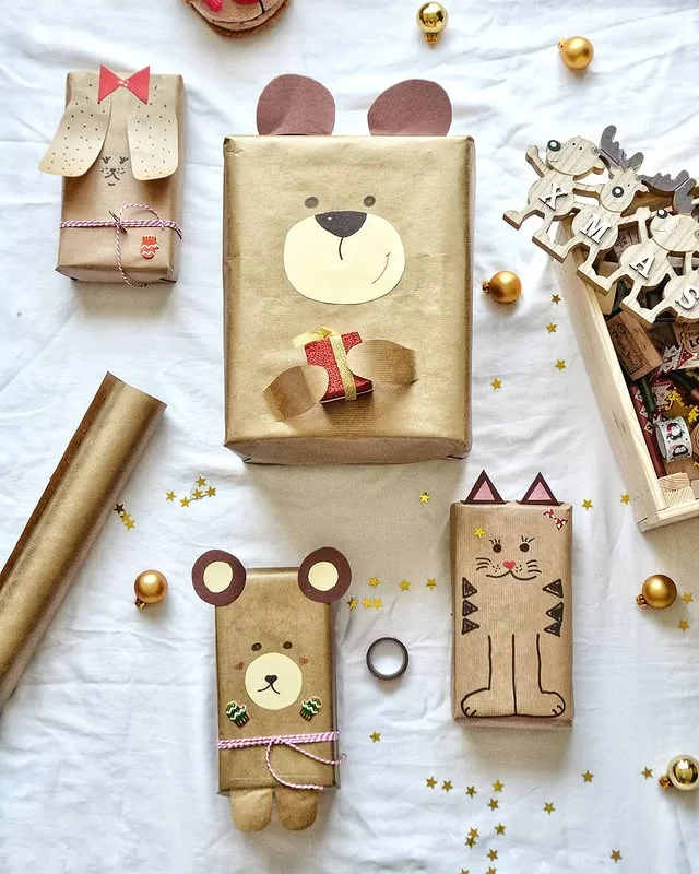 Kraft wrapped gifts decorated as hand drawn bears, dogs and cats