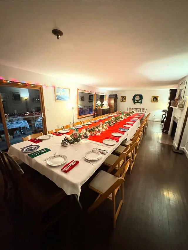 Long banquet tables styled for a Christmas party feast