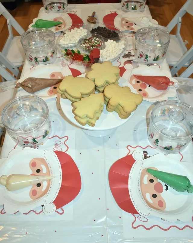 Christmas cookie decorating station with frosted cookies