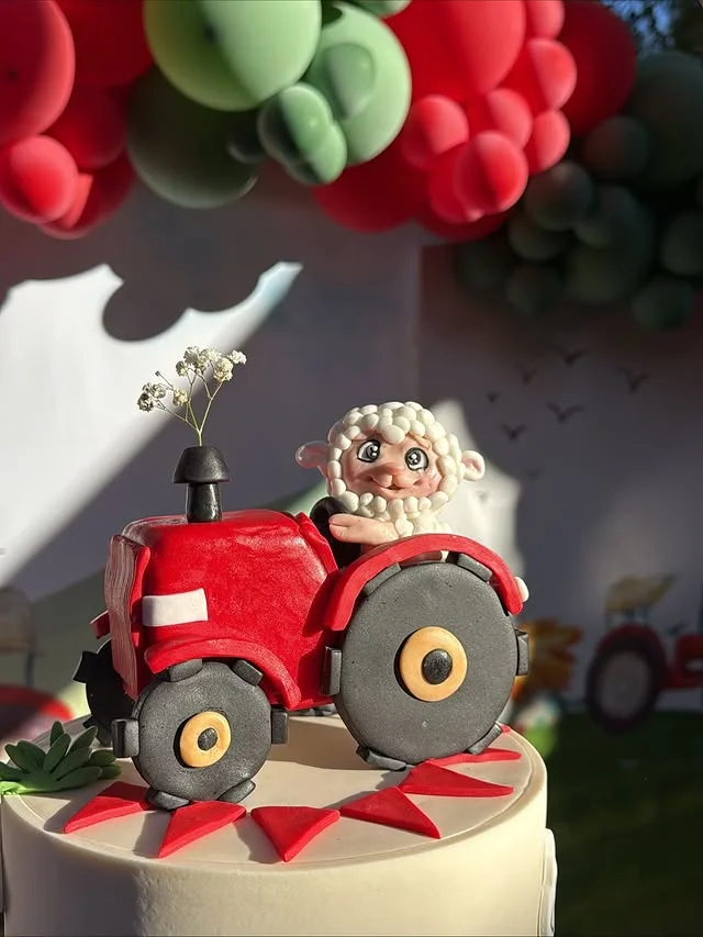 Tractor birthday cake with sheep fondant topper and balloon garland