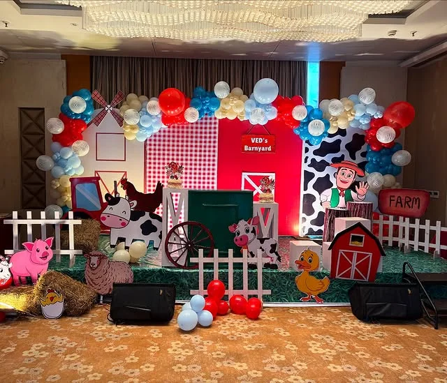 Barnyard birthday stage with cow, pig, windmill and tractor cutouts