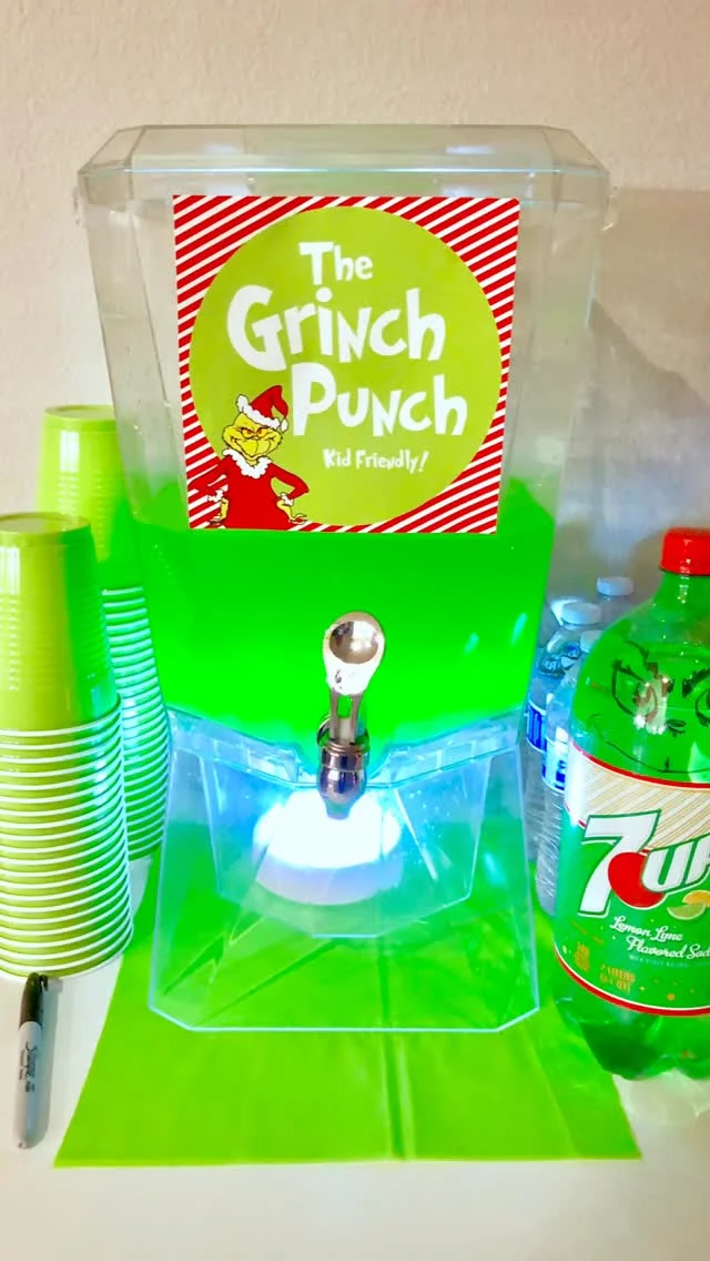 Beverage dispenser filled with bright green Grinch punch