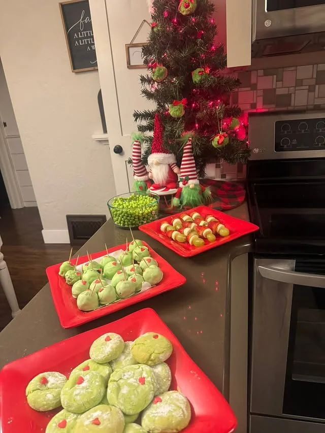 Kids party counter with Grinch cookies, cake pops and fruit skewers