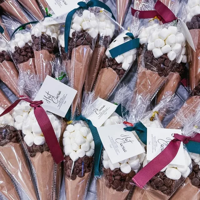 Hot cocoa gift cones filled with cocoa mix, chocolate chips and marshmallows