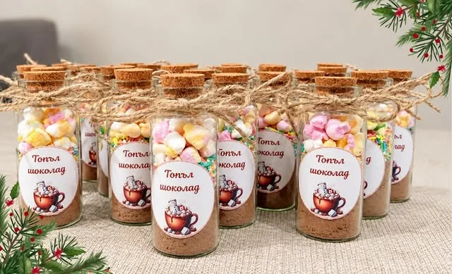 Glass jars of hot cocoa mix with cork lids, marshmallows and twine