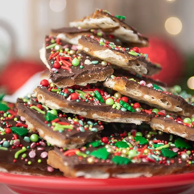 Stacked pieces of Christmas toffee bark with red and green sprinkles