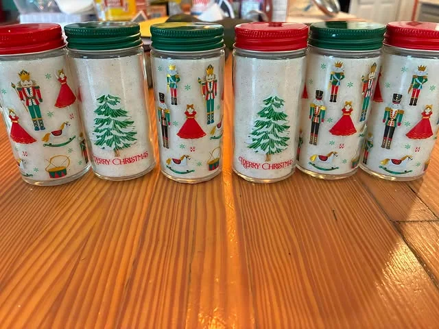 Tall bottles of vanilla sugar with nutcracker and Christmas tree designs