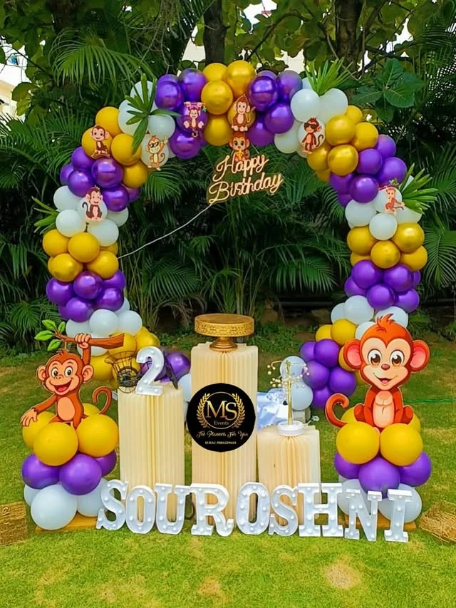 Purple and yellow monkey themed balloon arch