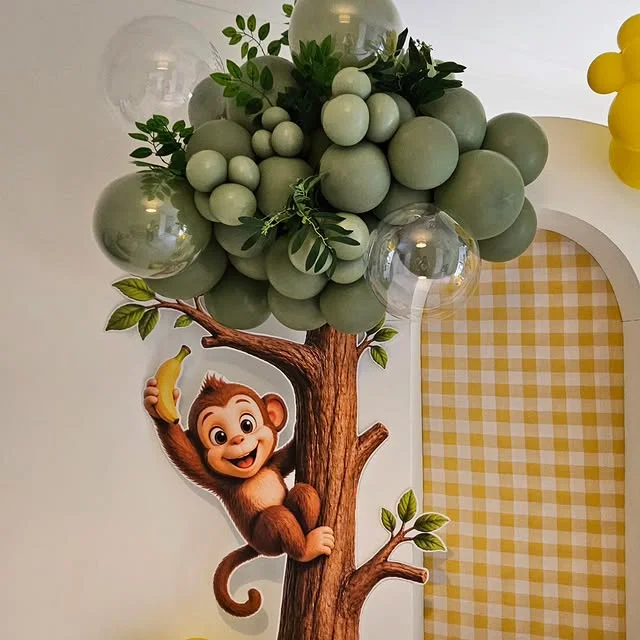 Plush monkey sitting in a balloon tree decoration