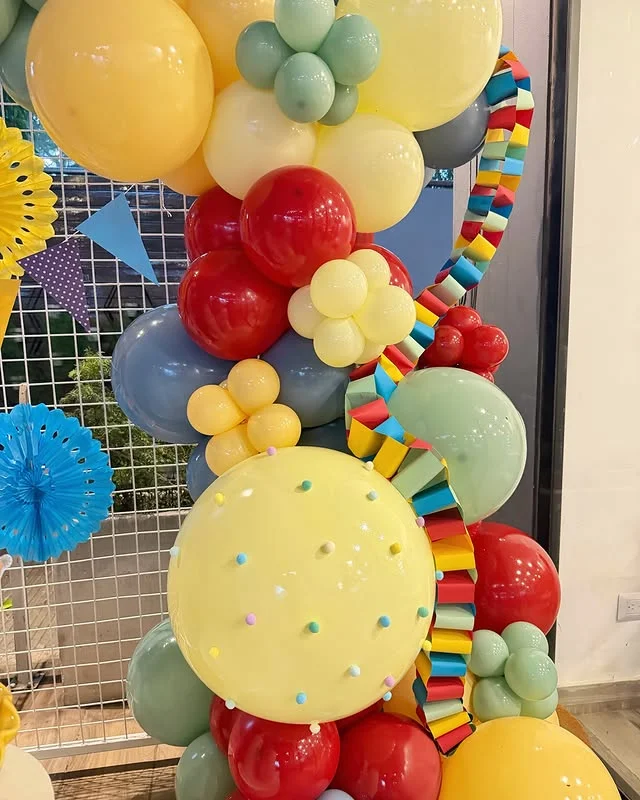 Close up of a colorful balloon garland with red, yellow, mint and blue balloons
