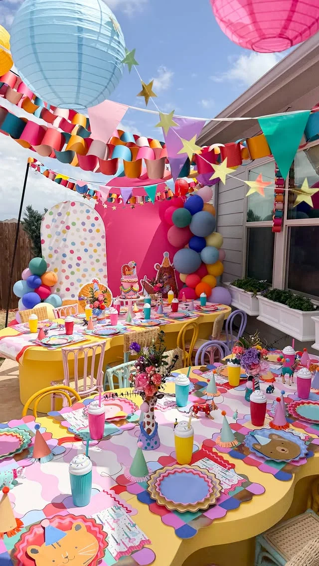 Colorful kids party table with bunting, balloons and animal themed tableware