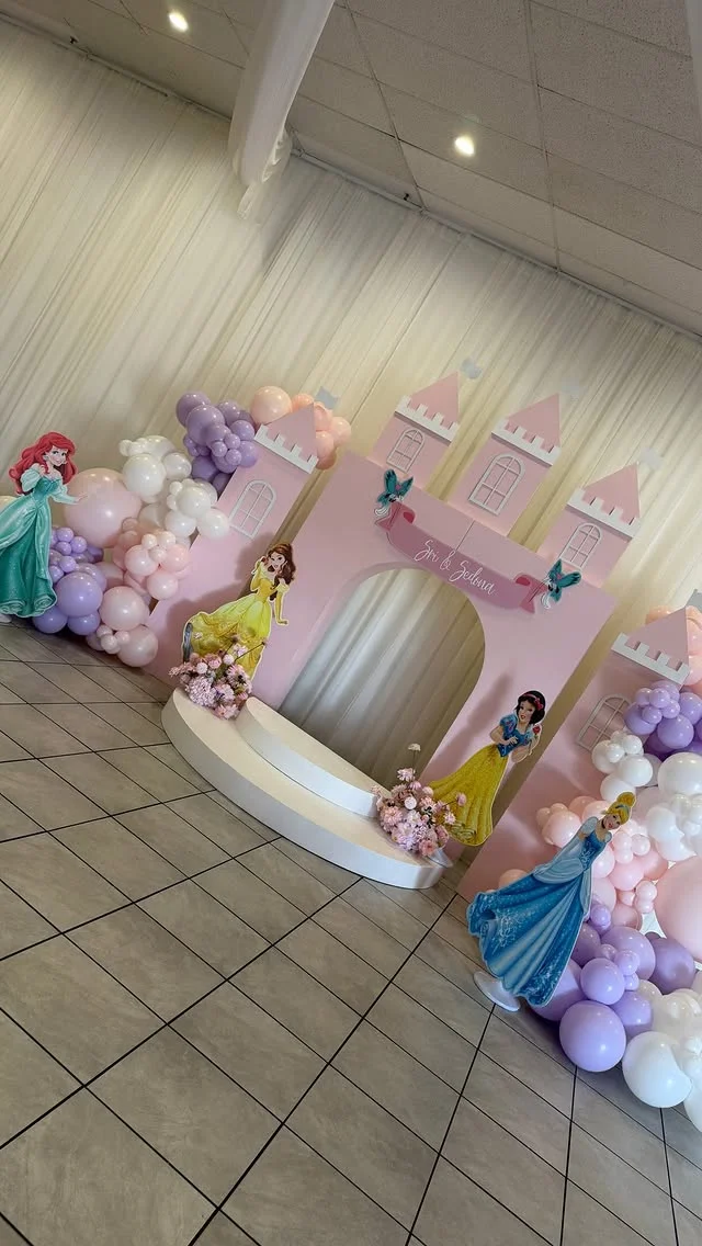 Joint princess birthday setup with a castle backdrop for two girls