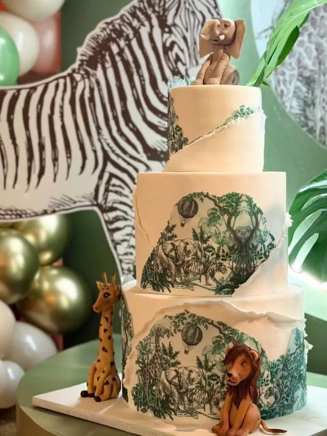 Three tier jungle mural cake with zebra backdrop and animal figures