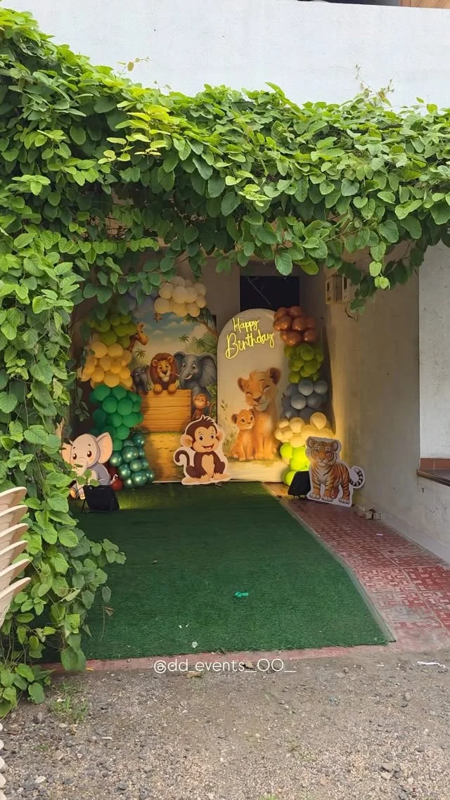 Leafy jungle entrance tunnel with animal cutouts and a green carpet path