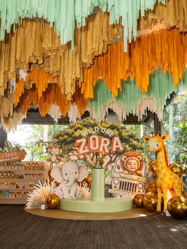 Wild One dessert stage with fringe canopy and animal figures