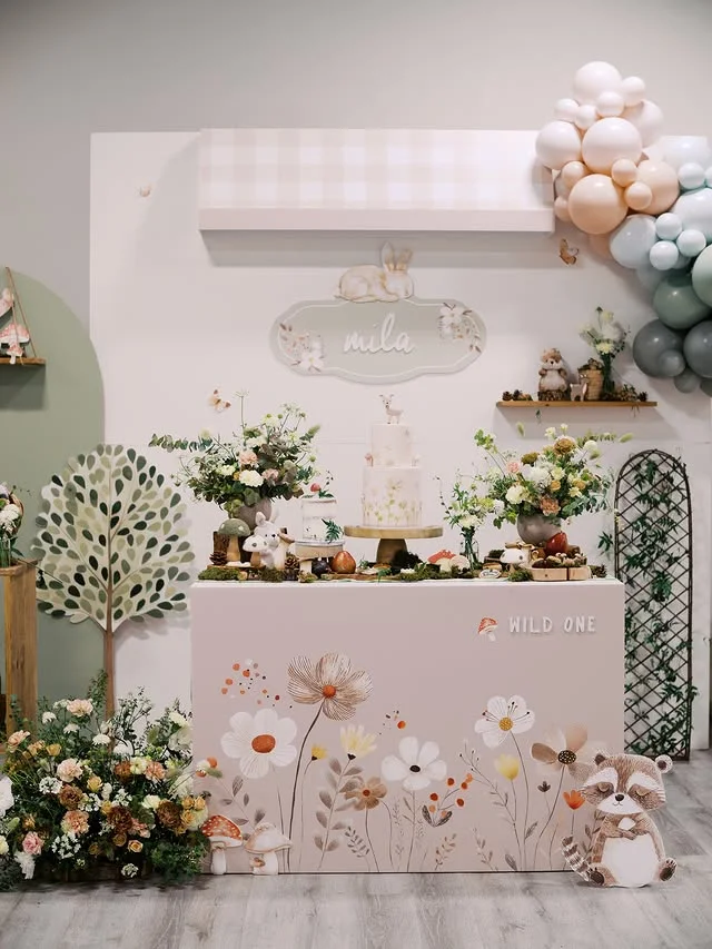 Soft Wild One dessert table with floral decor and animal accents